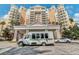 Luxury building exterior with a shuttle and cars parked in front at 875 Assembly Ct, Reunion, FL 34747