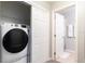 Convenient laundry room with washer, dryer, and storage at 875 Assembly Ct, Reunion, FL 34747