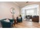 Cozy living room with sectional sofa, hardwood floors, and large windows at 875 Assembly Ct, Reunion, FL 34747