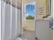Charming bathroom with a shower/tub combo, window, and neutral color scheme at 1018 Wilks Ave, Belle Isle, FL 32809