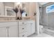 Double vanity bathroom with frameless shower at 1018 Wilks Ave, Belle Isle, FL 32809