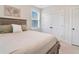 Cozy bedroom with a queen-size bed and double doors leading to a closet at 1018 Wilks Ave, Belle Isle, FL 32809