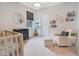 Adorable Bedroom with a crib, glider, and plenty of storage at 1018 Wilks Ave, Belle Isle, FL 32809
