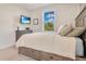 Spacious bedroom with a queen-size bed, dresser, and wall-mounted TV at 1018 Wilks Ave, Belle Isle, FL 32809
