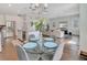 Open dining area with glass table and chairs, offering a view of the living room at 1018 Wilks Ave, Belle Isle, FL 32809