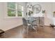 Elegant dining area with a glass table, grey chairs, and a stylish buffet at 1018 Wilks Ave, Belle Isle, FL 32809