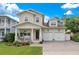 Two-story house with a two car garage, front porch, and landscaped yard at 1018 Wilks Ave, Orlando, FL 32809