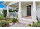 Front porch with rocking chairs and lush landscaping at 1018 Wilks Ave, Orlando, FL 32809