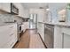 Modern kitchen with white cabinets, granite countertops, and stainless steel appliances at 1018 Wilks Ave, Belle Isle, FL 32809
