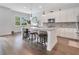 Spacious kitchen with white cabinets, granite island, and stainless steel appliances at 1018 Wilks Ave, Belle Isle, FL 32809