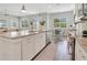 Island kitchen with granite countertops, white cabinets, and stainless steel appliances at 1018 Wilks Ave, Belle Isle, FL 32809