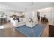 Open living space featuring hardwood floors, comfortable seating, and a large TV at 1018 Wilks Ave, Belle Isle, FL 32809