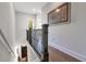 Elegant staircase with dark wood railing and hardwood floors at 1018 Wilks Ave, Belle Isle, FL 32809
