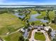 Aerial view of golf course community with clubhouse and lake at 10279 Beechwood Ln, Orlando, FL 32832