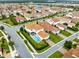 Aerial view of a two-story house with a pool in a residential community at 10279 Beechwood Ln, Orlando, FL 32832