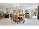 Bright dining room with a dark wood table, woven chairs, and open concept floorplan at 10279 Beechwood Ln, Orlando, FL 32832