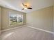 Bright bedroom with neutral walls, ceiling fan and plush carpeting at 1101 E Pierce Ave, Orlando, FL 32809