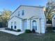Two-story house with light beige exterior, two-car garage, and landscaping at 1241 Melontree Ct # 6, Gotha, FL 34734
