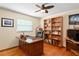 Home office with large desk and built-in bookshelves at 369 Forest Park Cir, Longwood, FL 32779