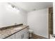 Bathroom with granite countertop, white cabinets, and bathtub at 3807 S Atlantic Ave # 2020, Daytona Beach, FL 32118