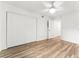 Spacious bedroom with hardwood floors, double door closet, and access to another room at 3807 S Atlantic Ave # 2020, Daytona Beach, FL 32118