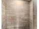 Shower with light brown tile and a decorative accent tile at 3807 S Atlantic Ave # 2020, Daytona Beach, FL 32118