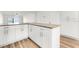 Modern kitchen with white cabinets, granite countertops and pantry at 3807 S Atlantic Ave # 2020, Daytona Beach, FL 32118