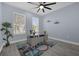 Bright office with wood-look floors, desk, and two windows at 3814 Golden Feather Way, Kissimmee, FL 34746