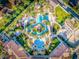 Resort-style pool with surrounding lounge chairs and landscaping; aerial view at 408 Miramar Avenue, Davenport, FL 33897