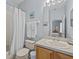 Bathroom with tub, shower, toilet, and wood vanity at 408 Miramar Avenue, Davenport, FL 33897