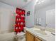 Bathroom with tub, toilet and Mickey Mouse decor at 408 Miramar Avenue, Davenport, FL 33897