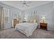 Cozy bedroom with a queen-size bed, nightstands, and dresser at 408 Miramar Avenue, Davenport, FL 33897