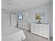 Main bedroom with king-size bed, dresser, and access to bathroom at 408 Miramar Avenue, Davenport, FL 33897