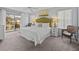 Main bedroom with king-size bed, balcony access, and seating area at 408 Miramar Avenue, Davenport, FL 33897