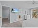 Main bedroom with king-size bed, dresser, and access to bathroom and balcony at 408 Miramar Avenue, Davenport, FL 33897