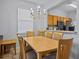 Bright dining room with wood table and chairs, chandelier, and kitchen pass-through at 408 Miramar Avenue, Davenport, FL 33897
