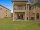 Exterior view of a two-story townhome with patio and balcony at 408 Miramar Avenue, Davenport, FL 33897
