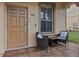 Small front patio with two wicker chairs and a side table at 408 Miramar Avenue, Davenport, FL 33897