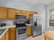 Kitchen with stainless steel appliances and wood cabinets at 408 Miramar Avenue, Davenport, FL 33897