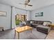 Spacious living room with L-shaped sectional sofa and large window at 408 Miramar Avenue, Davenport, FL 33897