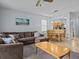 Open living and dining area with L-shaped sectional sofa and dining table at 408 Miramar Avenue, Davenport, FL 33897