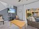 Living room with sectional sofa, coffee table, and wall-mounted TV at 408 Miramar Avenue, Davenport, FL 33897