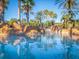 Clear blue pool reflecting palm trees and blue sky at 408 Miramar Avenue, Davenport, FL 33897