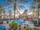 Resort-style pool with lounge chairs and palm trees under a clear sky at 408 Miramar Avenue, Davenport, FL 33897