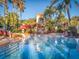 Inviting pool with waterslide, palm trees, and plenty of lounge chairs at 408 Miramar Avenue, Davenport, FL 33897