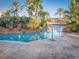 Relaxing pool area with a rock feature and palm trees at 408 Miramar Avenue, Davenport, FL 33897