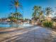 Inviting resort-style pool with palm trees and a relaxing spa at 408 Miramar Avenue, Davenport, FL 33897