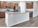 Kitchen island with granite countertop and wood cabinets at 4085 Sandhill Pl, Leesburg, FL 34748