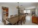 Bright dining room with large table and view into the living room and kitchen at 664 Little Wekiva Rd, Altamonte Springs, FL 32714