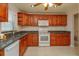 Kitchen with wood cabinets, granite countertops, and stainless steel appliances at 664 Little Wekiva Rd, Altamonte Springs, FL 32714